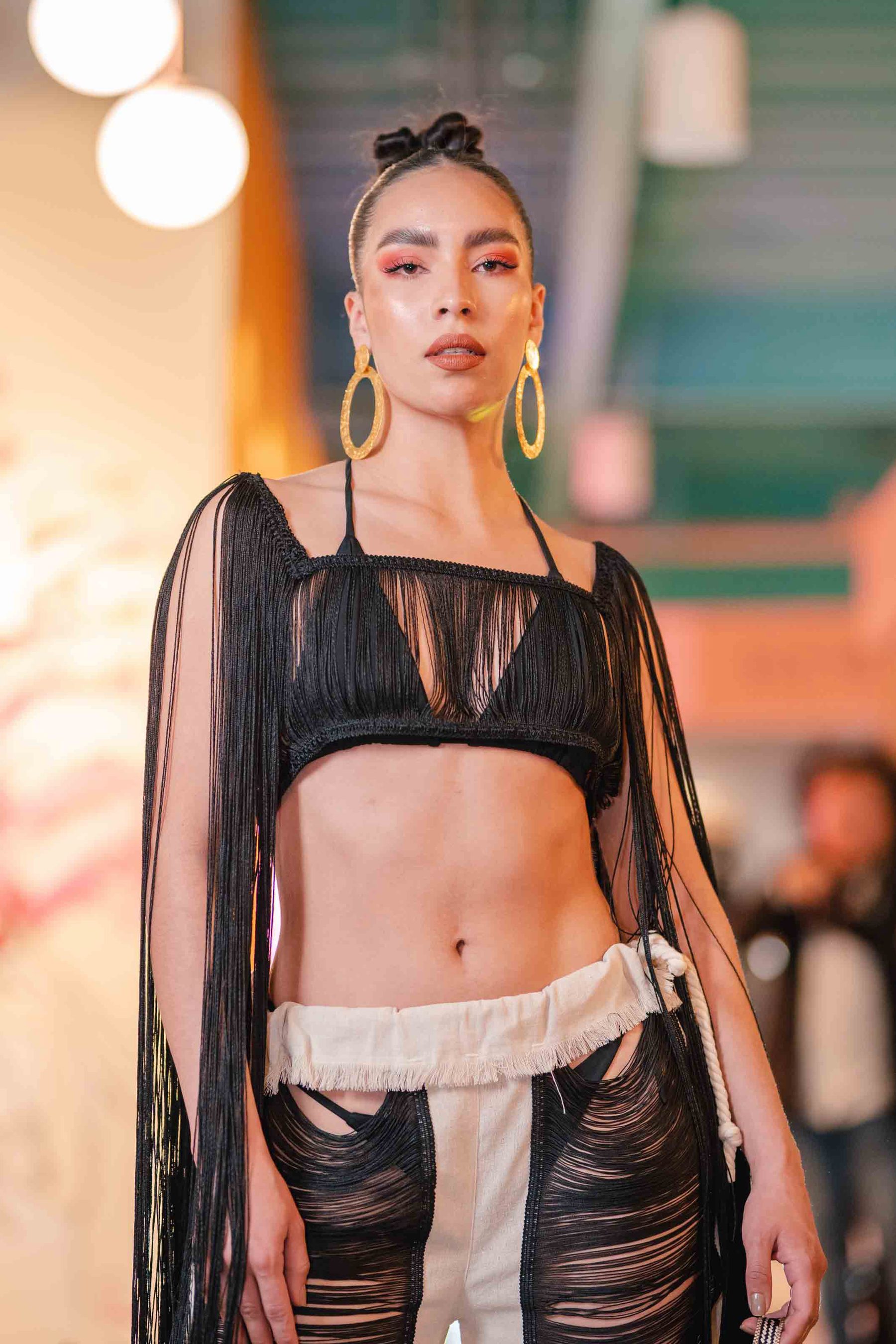 Model in black sheer on the runway