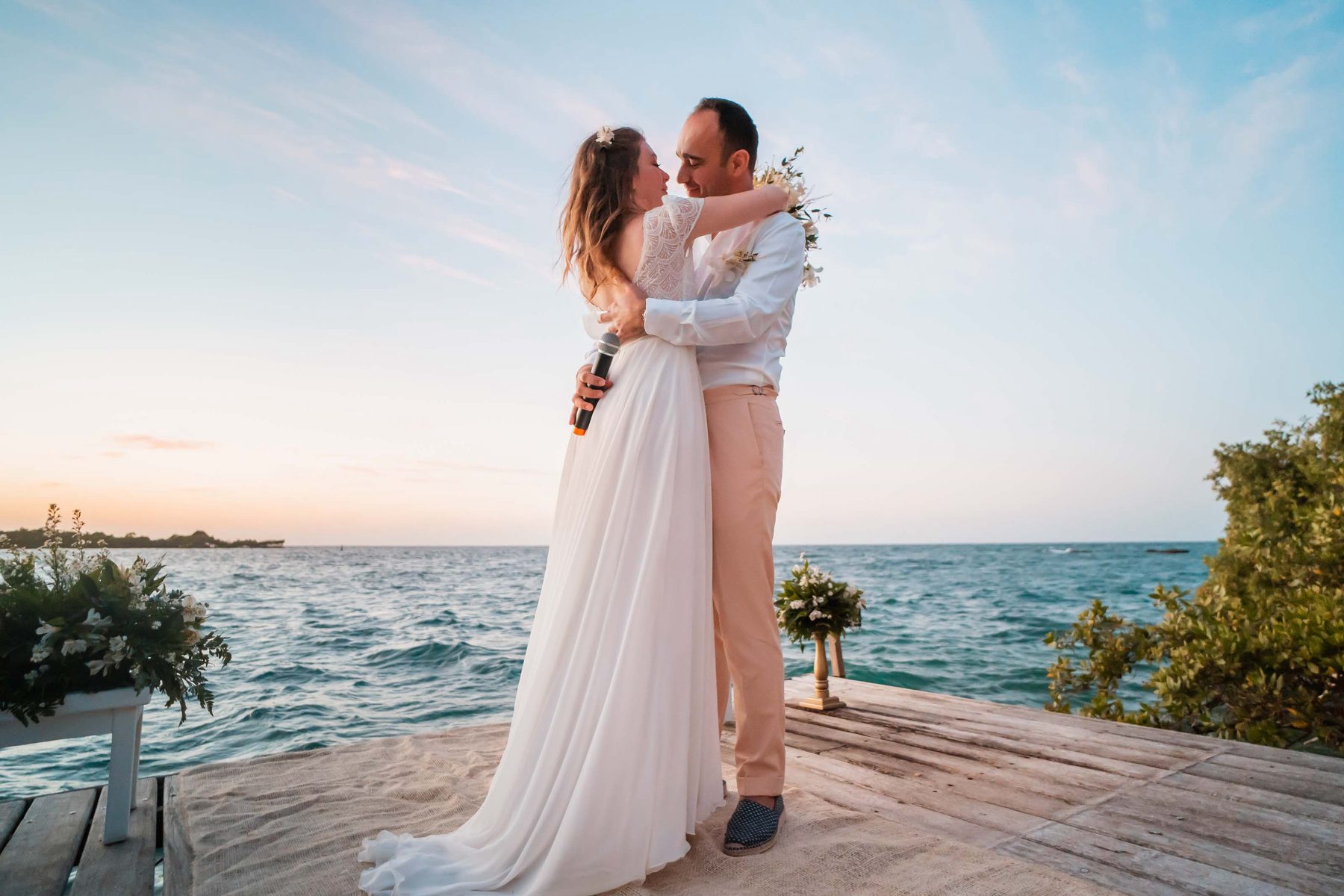 Couple embracing at sunset by the sea