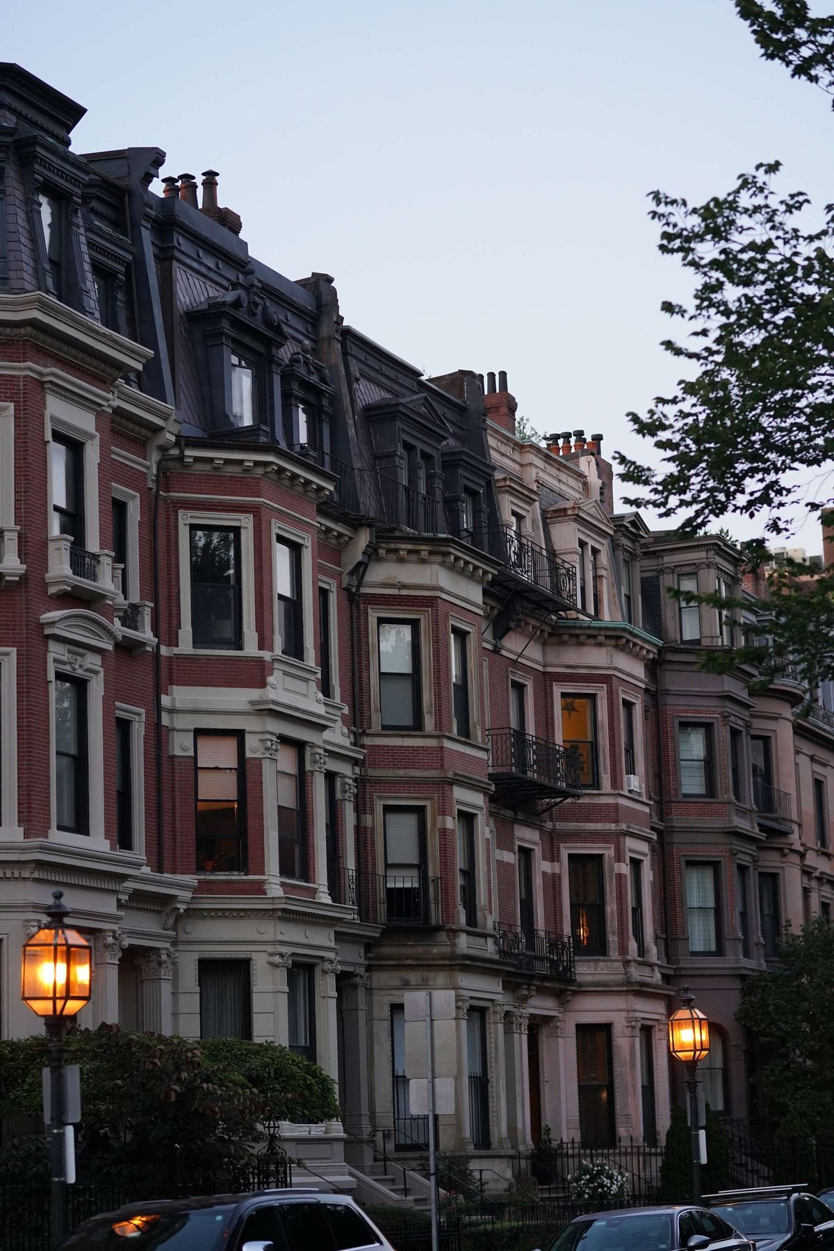 Brownstones and gas lamps at dusk