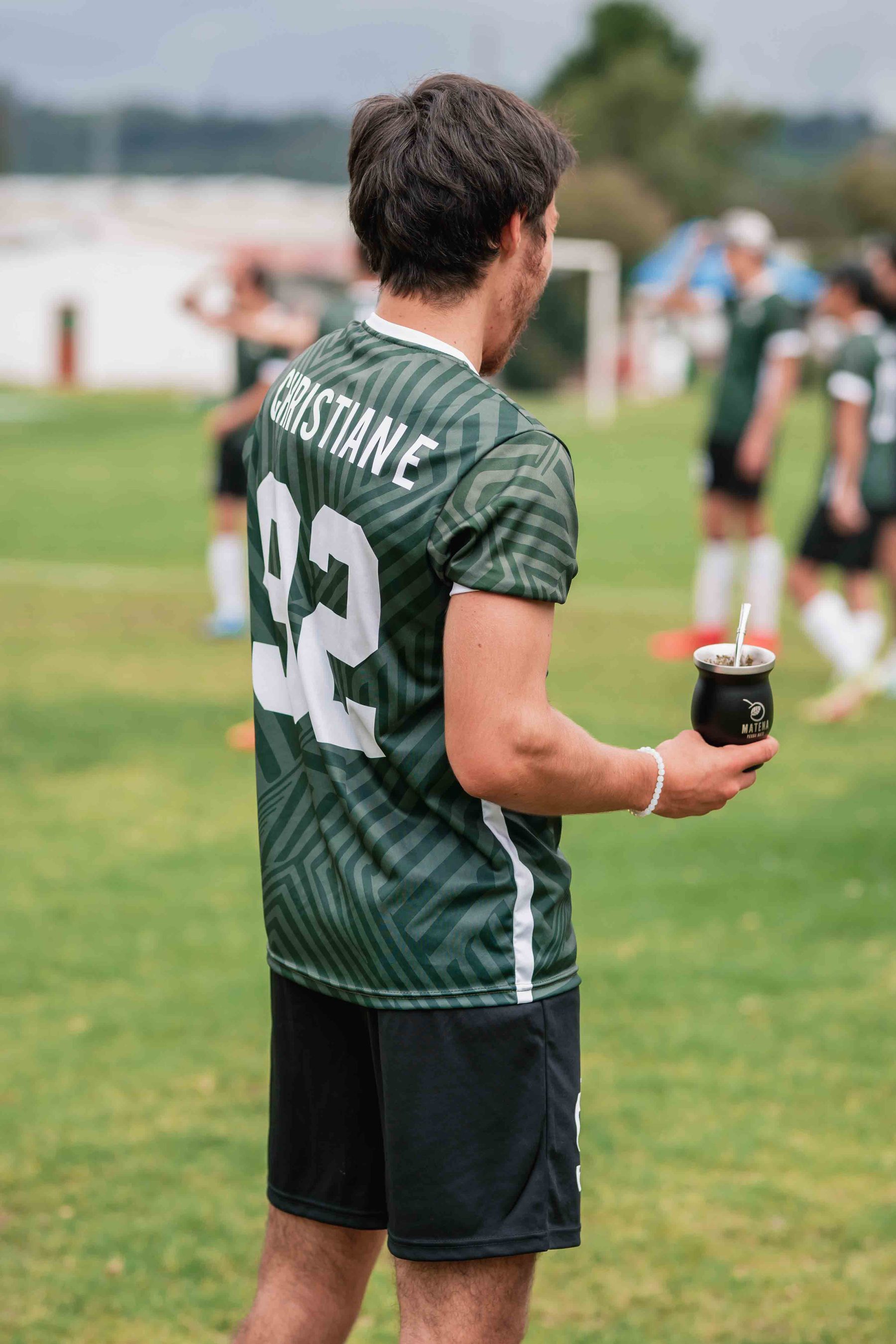 Player number 92 drinking mate on the field