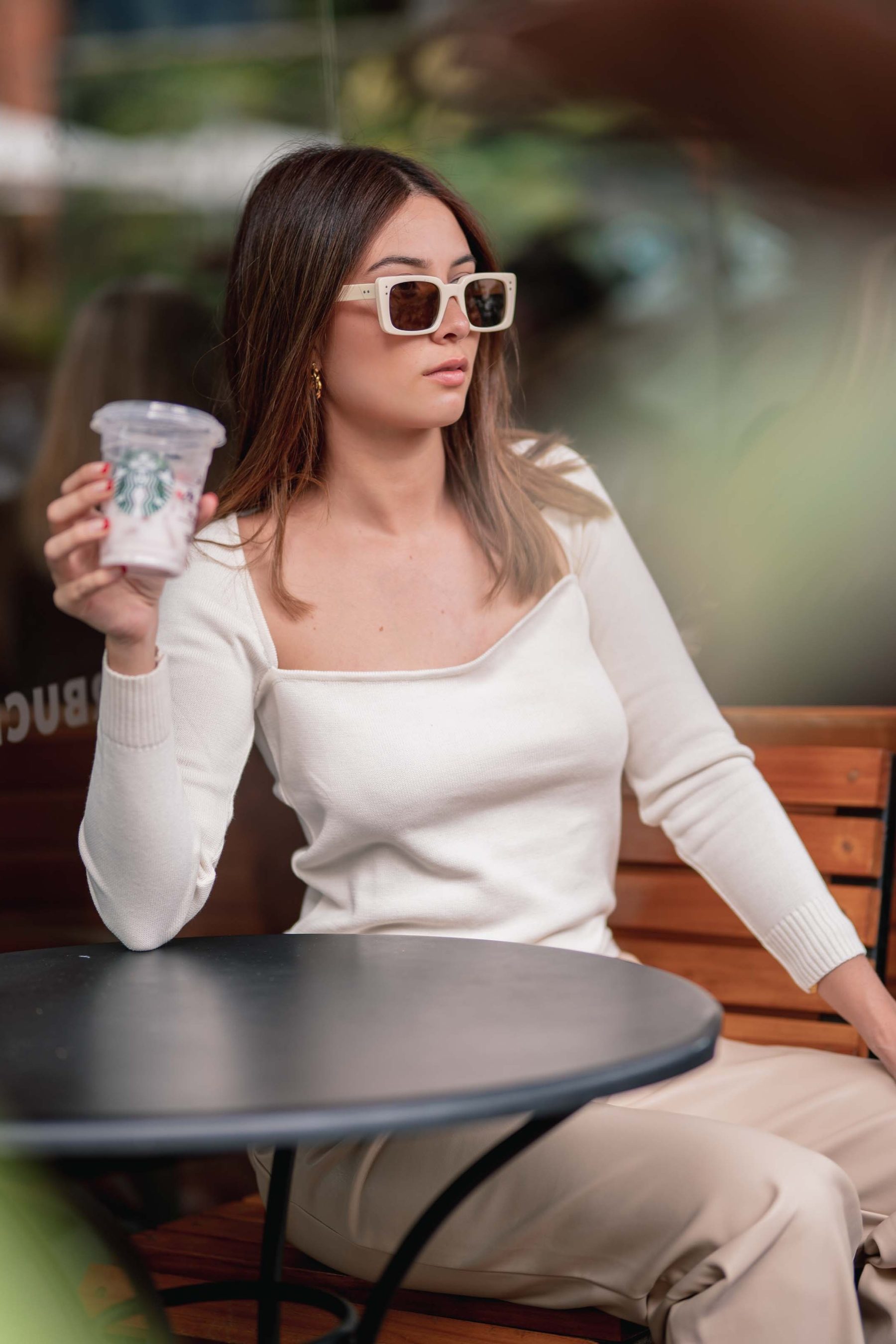 Woman with sunglasses and a coffee