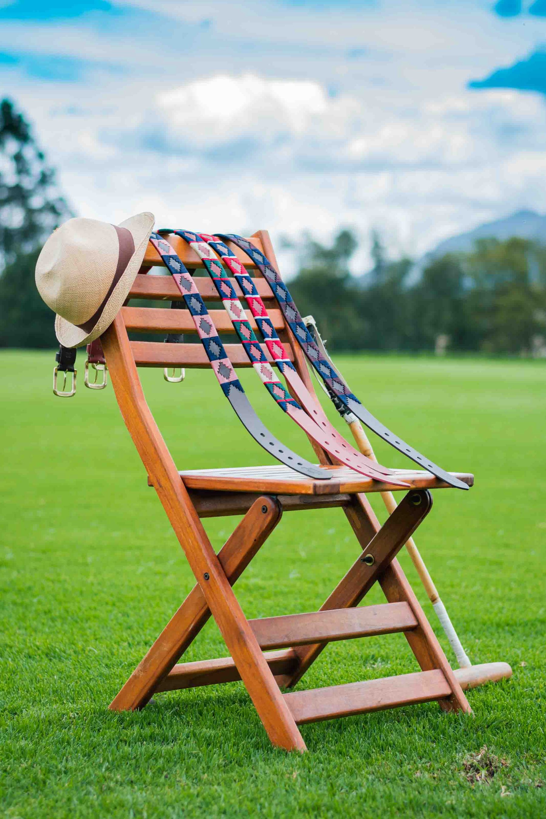 Belts hung on a wooden chair by the field