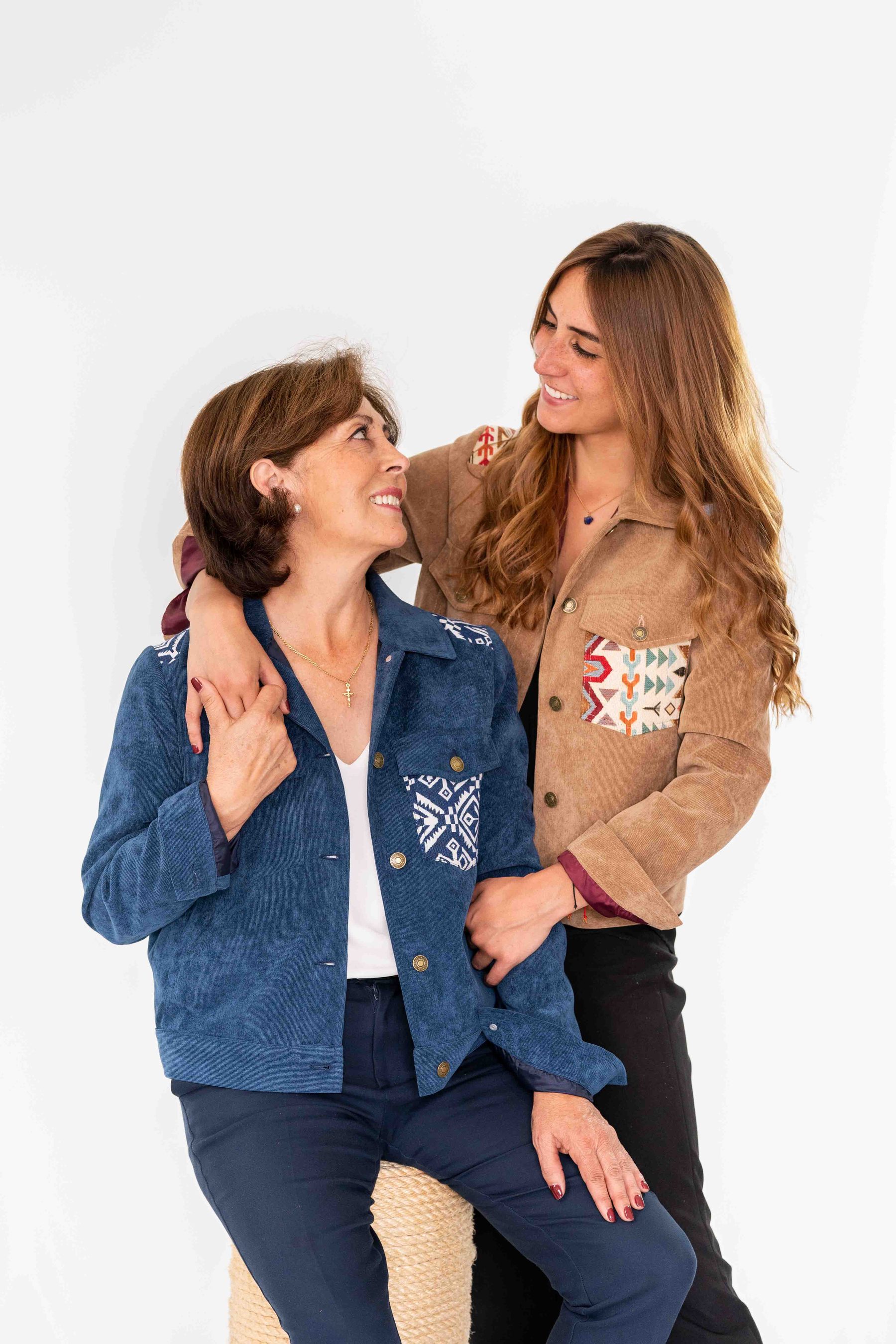 Two women in embroidered denim and suede