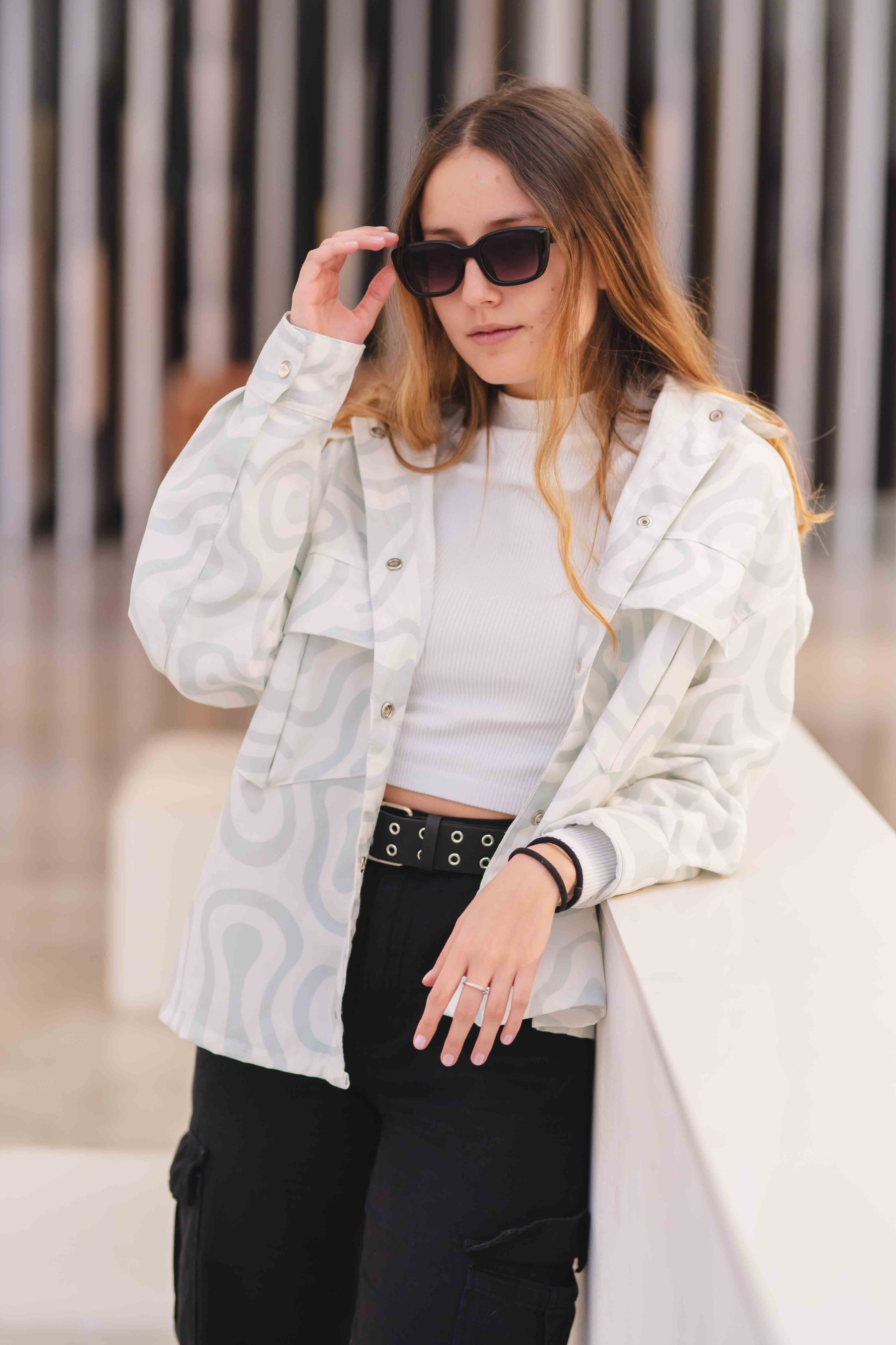 Model in a printed jacket with sunglasses