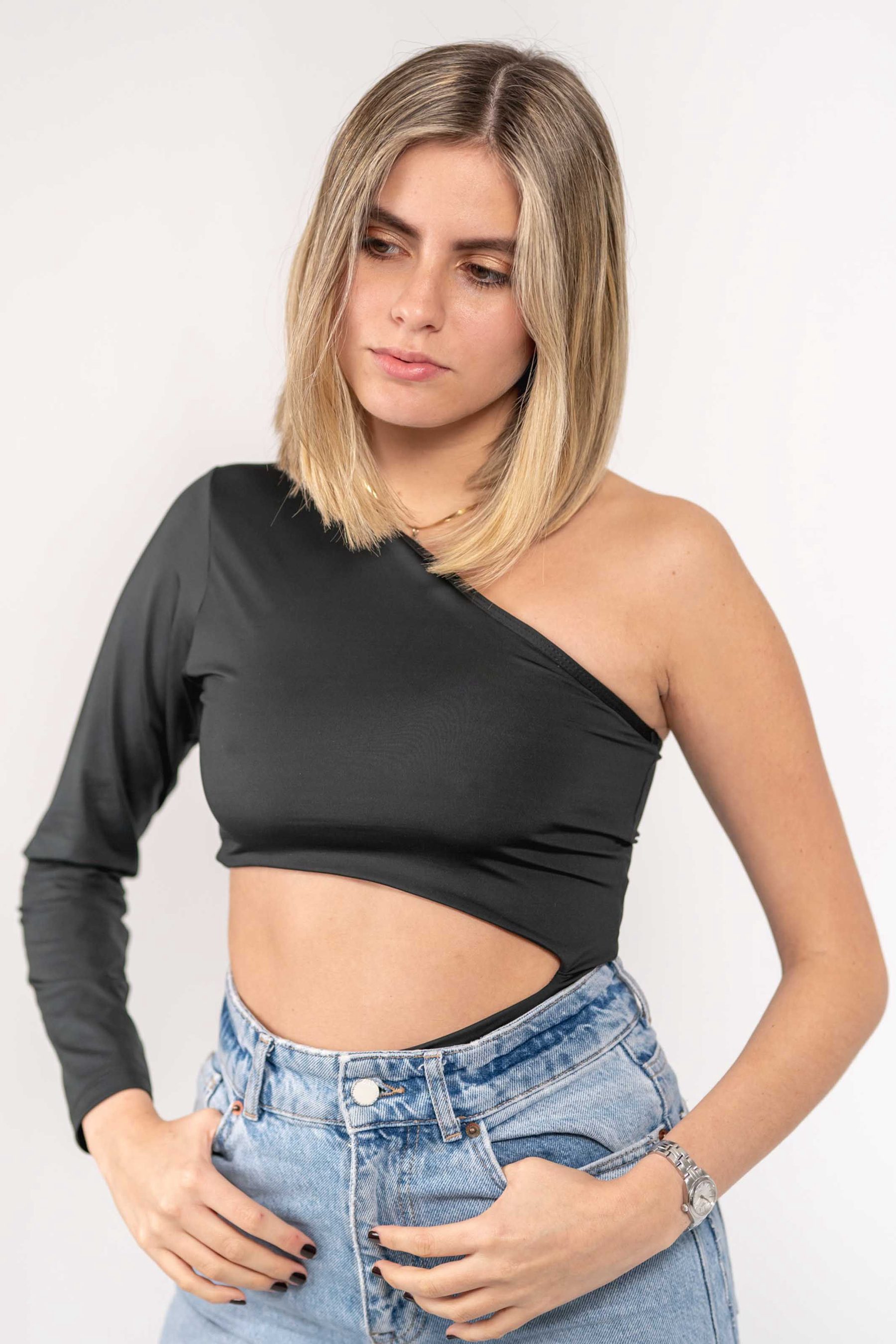 Model in a black one-shoulder top