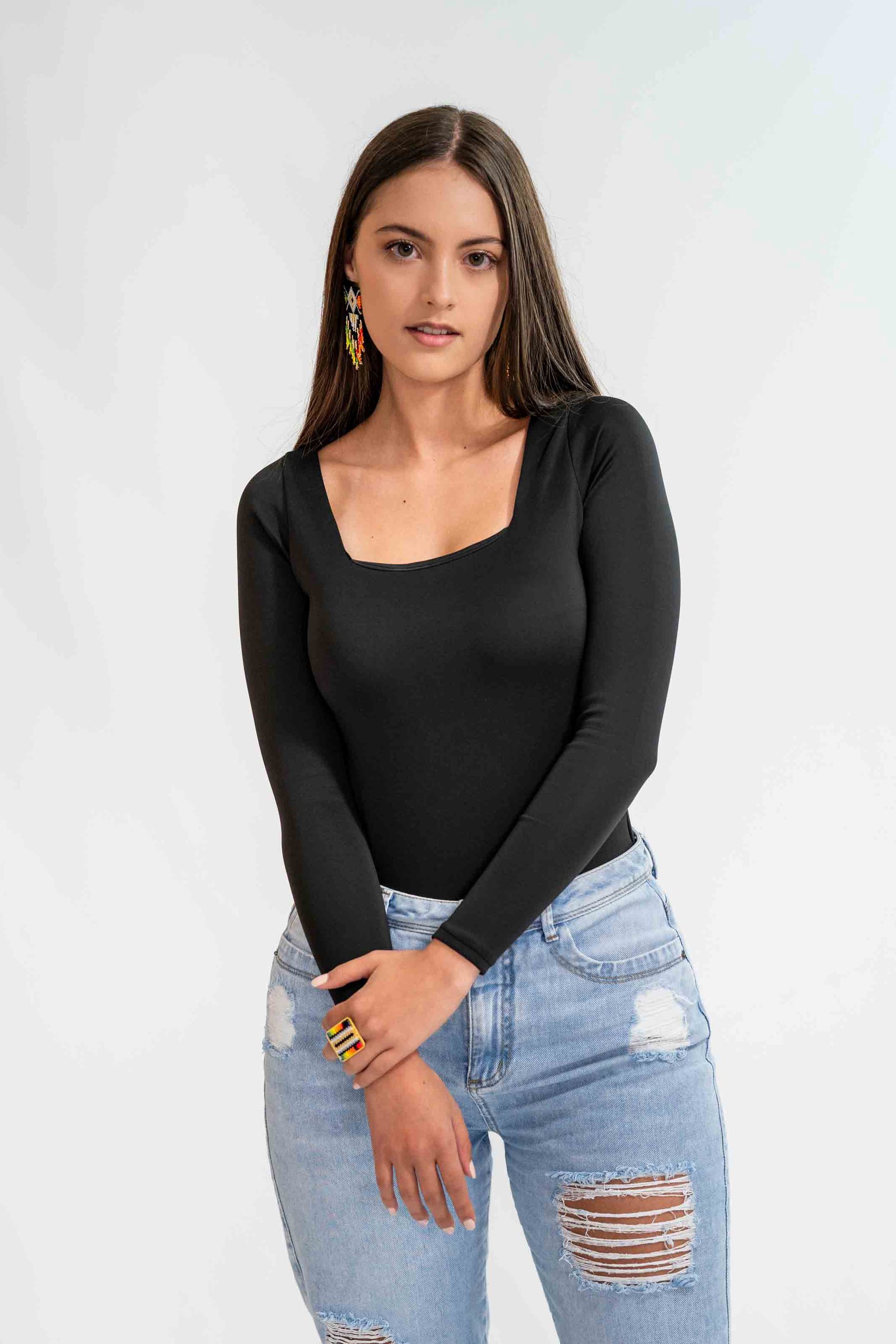 Model in a black body with gold earrings