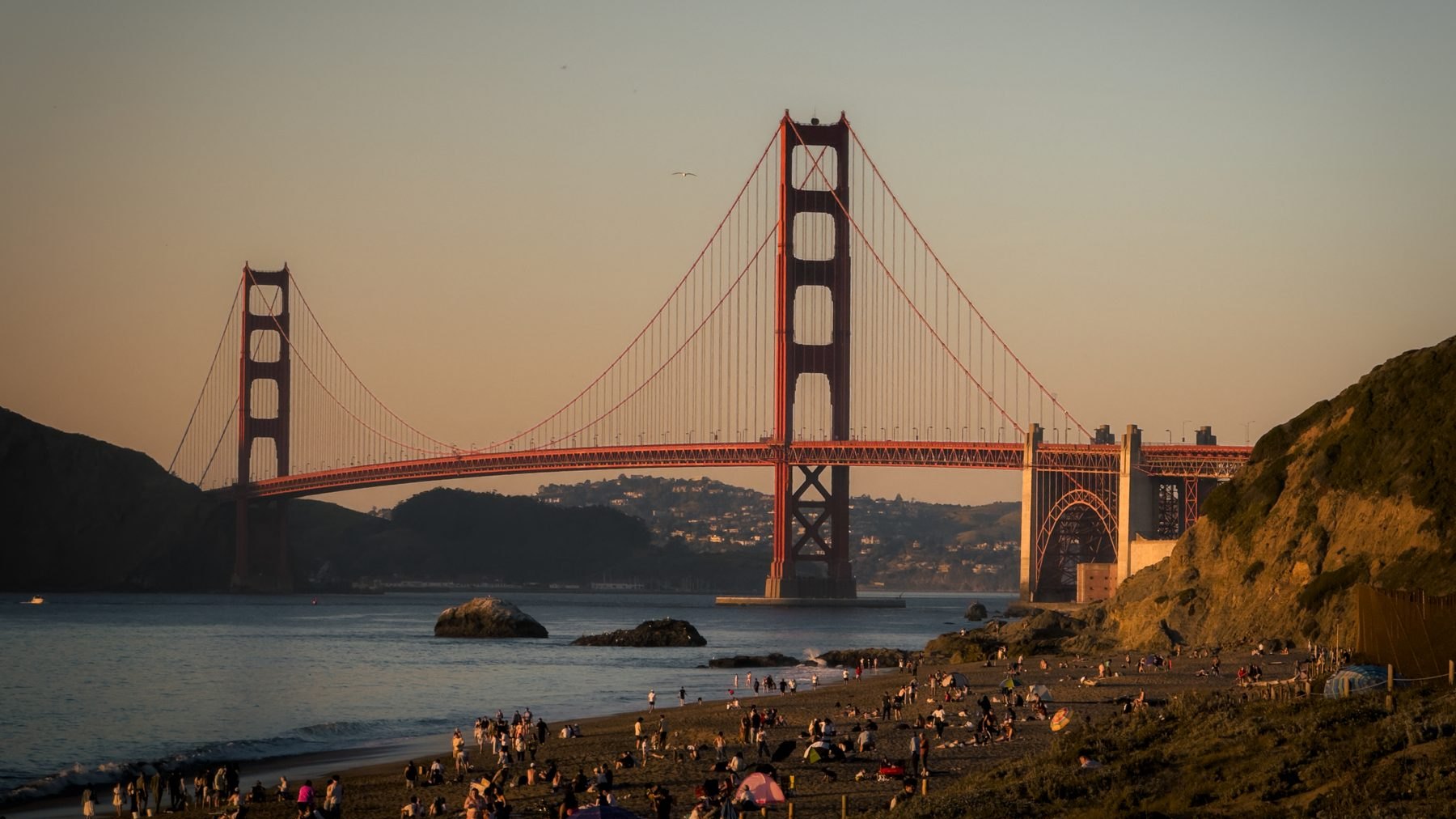 Crowd watching the Golden Gate at sunset from Baker Beach