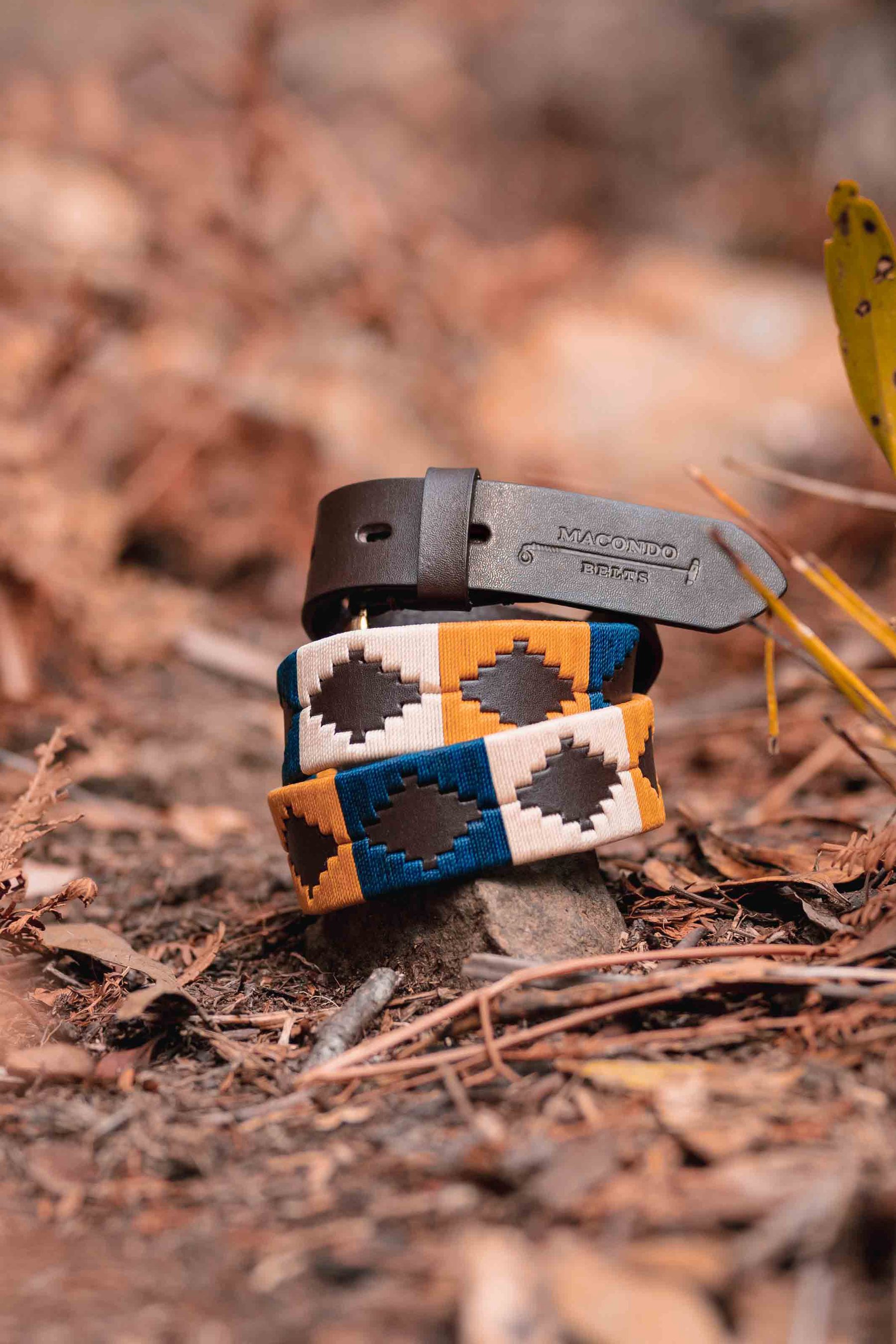 Woven Macondo belts stacked on rock