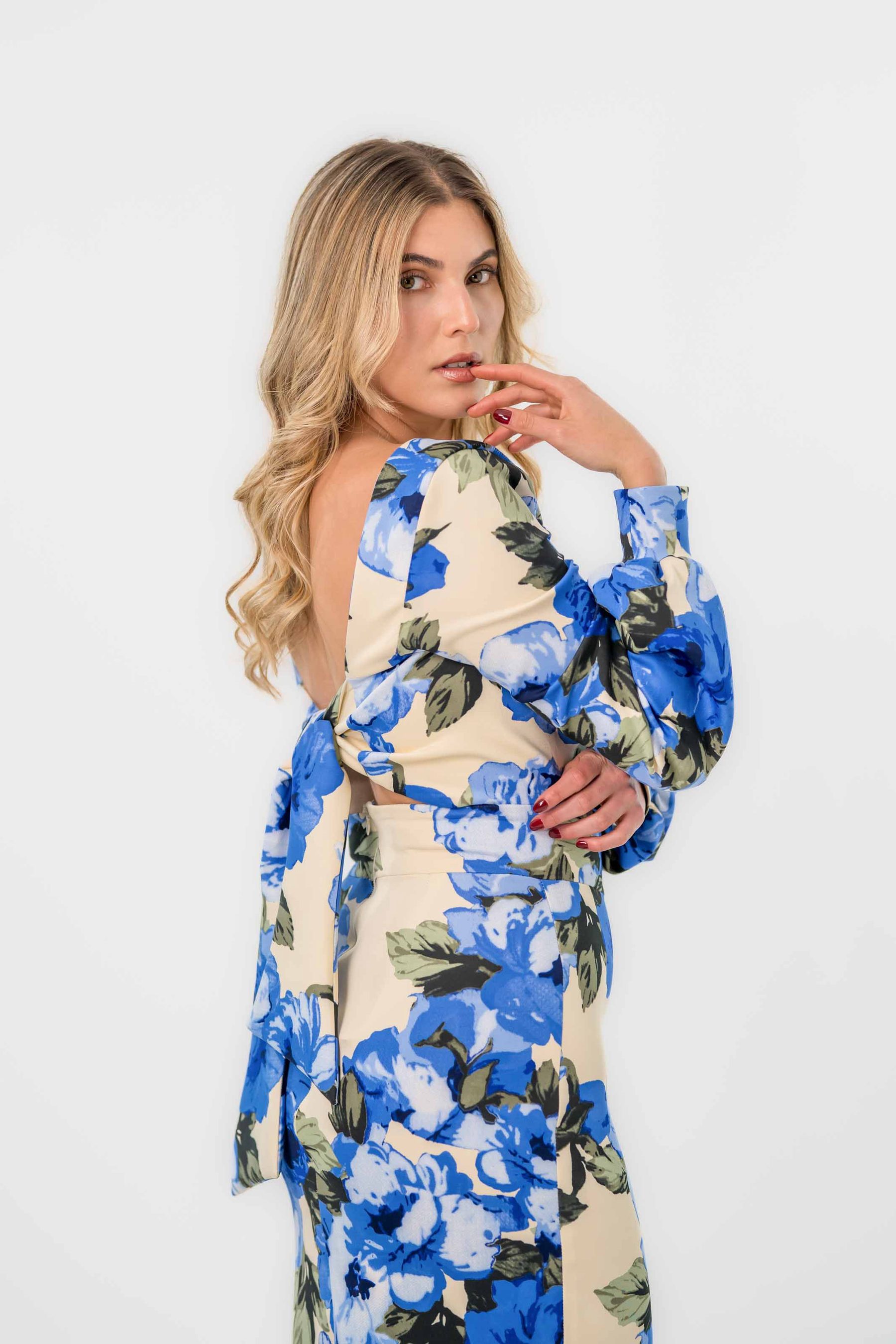 Model in a blue floral dress, seen from behind