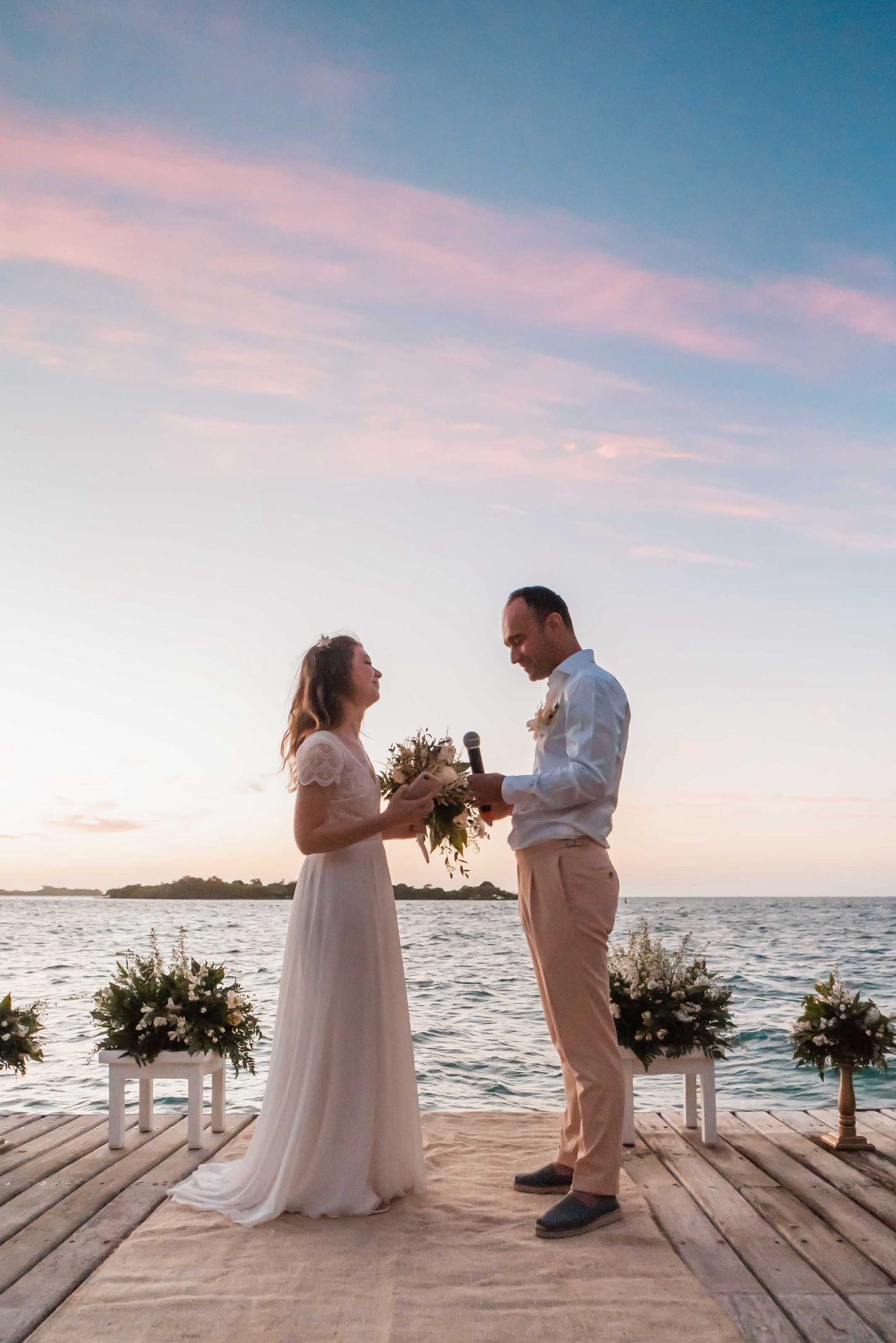 Couple with the bouquet at sunset