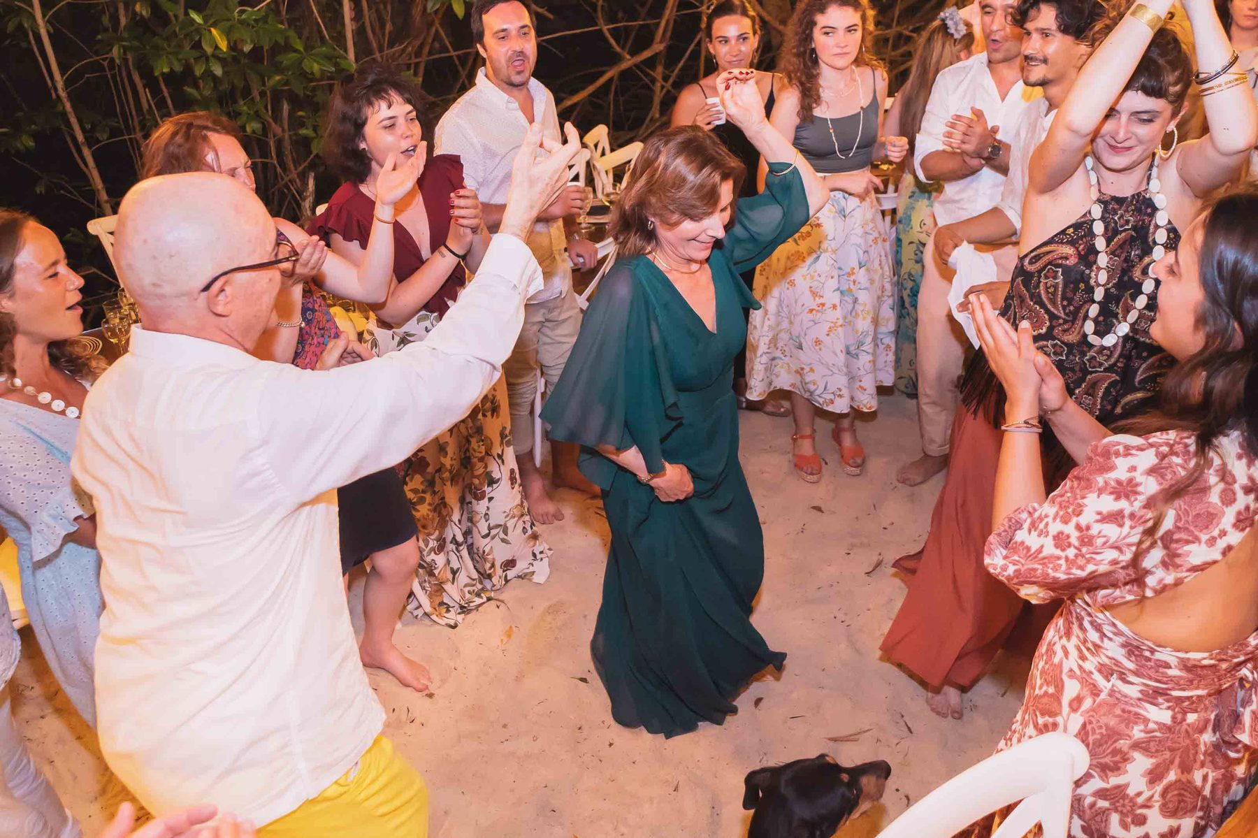 Guests dancing on the sand